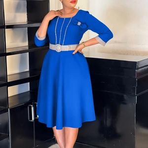 Detail of royal blue dress featuring check pattern belt and shoulder bow decoration