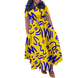 Detail of vibrant yellow African print dress with blue abstract patterns and waist tie
