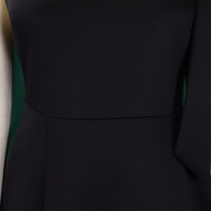 Detail shot of the waist stitching and fine fabric texture on a black evening gown