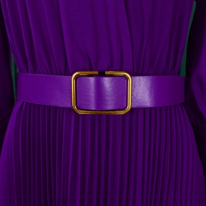 Detailed close-up of purple pleated dress featuring a matching leather belt with gold buckle