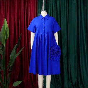 Detail of royal blue short sleeve dress featuring 3D handmade fabric rose decoration