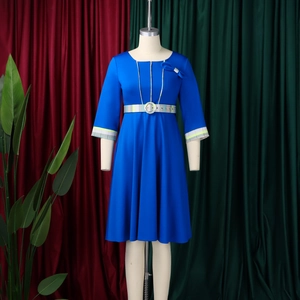 Close-up of royal blue dress featuring elegant bow detail and green plaid waist belt