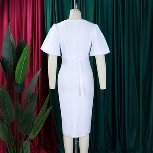 Detailed back view of white V-neck dress featuring long invisible zipper and waist tie