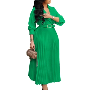 Detail of emerald green V-neck pleated maxi dress with elegant gold buckle waist belt