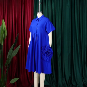 Detail of royal blue short sleeve A-line dress featuring a 3D rose floral embellishment