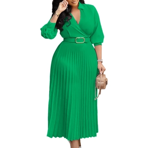 Detail of grass green pleated maxi dress featuring a V-neckline and belted waist with gold buckle