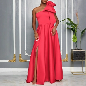 Detail view of the large oversized bow on the one-shoulder red evening gown bodice
