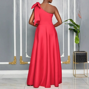 Detailed back view of a red one-shoulder evening gown featuring a large bow and satin finish