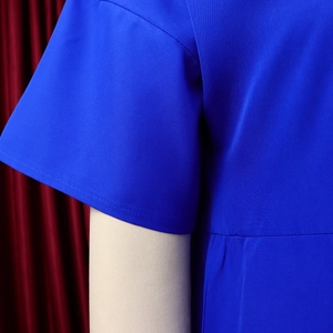 Detail of bright blue short sleeve with high-quality stitching on woven fabric dress