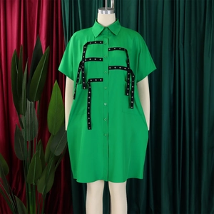Detail of bright green short-sleeved shirt dress with eyelet straps and button-down collar