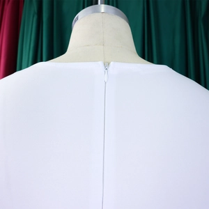 Detail of invisible zipper on white puff sleeve dress with horizontal fabric texture