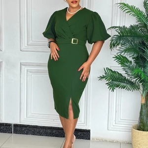 Detail of dark green V-neck dress featuring puff sleeves and a gold buckle waist belt