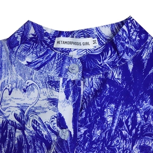 Détail de l'imprimé tropical flamant rose et des boutons du col sur cette robe d'été