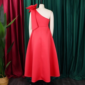 Detailed back view of a red one-shoulder evening gown with a large statement bow detail