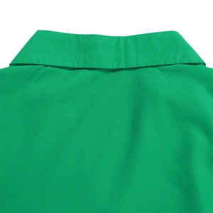 Close-up of elegant V-neckline and high-quality pleated fabric on green maxi dress