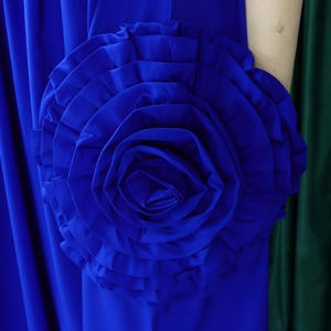 Detailed macro view of a large royal blue 3D chiffon rose on a stylish A-line dress