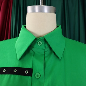 Detail shot of a green lapel shirt featuring black ribbon and silver metal eyelet accents