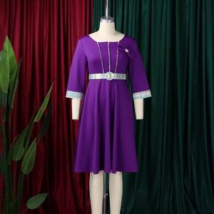 Detail of elegant purple dress showing plaid patchwork neckline and matching belt with buckle