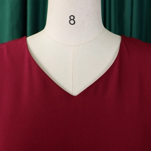 Close-up of elegant red V-neckline and high-quality woven fabric texture on a dress