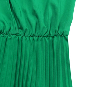 Macro shot of emerald green pleated fabric with elastic waist detail and stitching