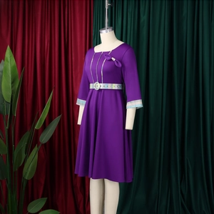 Detail of purple A-line dress featuring pleated bow neckline and colorful plaid patterns