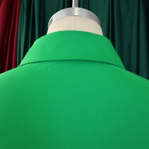 Detail of a bright green turn-down collar showing high-density stitching and woven texture