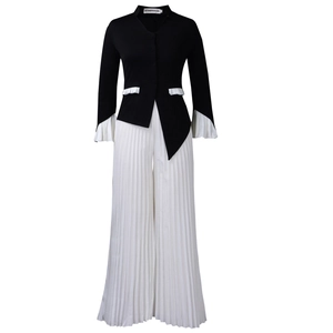 Detail of contrast patchwork sleeves and accordion pleats on the black and white set