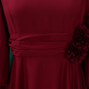 Detail of burgundy dress featuring pleated waist and handmade 3D floral accent