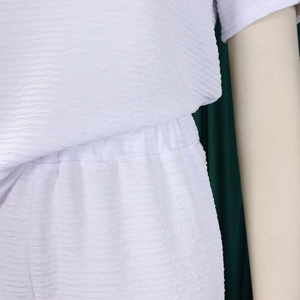 Détail de l'ensemble deux pièces blanc en tissu plissé avec taille haute élastiquée