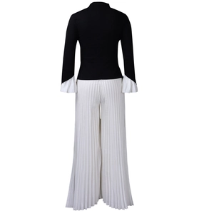 Back view of elegant black slim top with white pleated bell sleeves and wide-leg pants