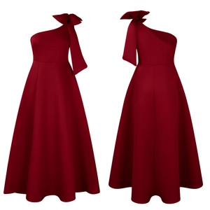 Detail of burgundy one-shoulder dress showing oversized bow and elegant A-line skirt