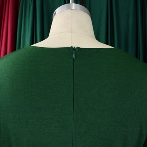 Detail of dark green dress showing back round neckline and hidden zipper closure