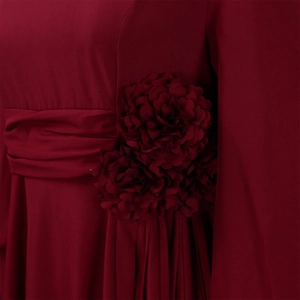 Detail of burgundy dress featuring handmade 3D fabric flowers and pleated waist design