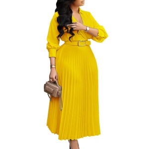 Detailed view of sun-yellow maxi dress with pleated skirt and cinched metal buckle belt