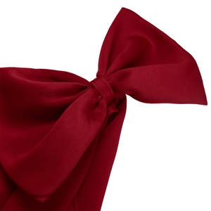 Close-up of a large burgundy bow made of textured satin fabric with thick material