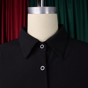 Detail shot of the black shirt dress lapel collar with unique two-tone buttons on fabric