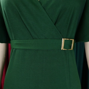 Detail of dark green dress showing V-neckline and belt with golden buckle