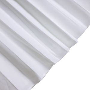 Detailed view of white pleated fabric with sharp texture on flare sleeve top and pants set