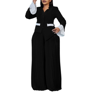 Detail of flared cuffs and pleated texture on a two-piece black and white set