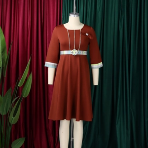Detail of terracotta midi dress featuring plaid trim sleeves and a matching plaid waist belt