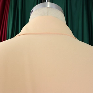 Detailed close-up of the collar structure and shoulder stitching on a beige short sleeve shirt