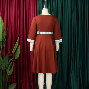 Detail view of the elegant midi dress featuring a rust red fabric and a plaid waist belt