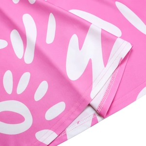 Detailed macro view of the smooth pink fabric texture and fine stitching on the dress hem