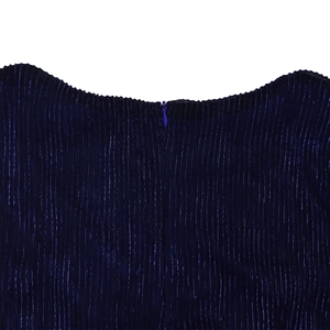 Close-up of pleated deep blue metallic fabric with a seamless hidden zipper detail