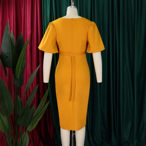 Back view of ginger yellow midi dress with puffed sleeves and invisible zipper closure
