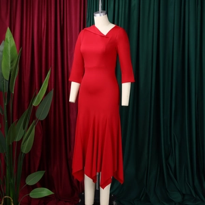 Detail of red asymmetric dress featuring cross V-neckline and irregular ruffle hemline