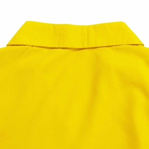 Detail of the V-neckline and back shoulder seam on the bright yellow cotton dress fabric