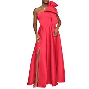 Detail of red one-shoulder evening gown featuring a large bow and high side slit