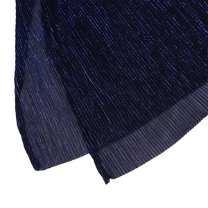 Detailed macro view of dark blue pleated fabric with metallic luster and subtle pearlescent finish