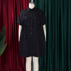 Detail of black short sleeve shirt dress with metal eyelet straps on mannequin